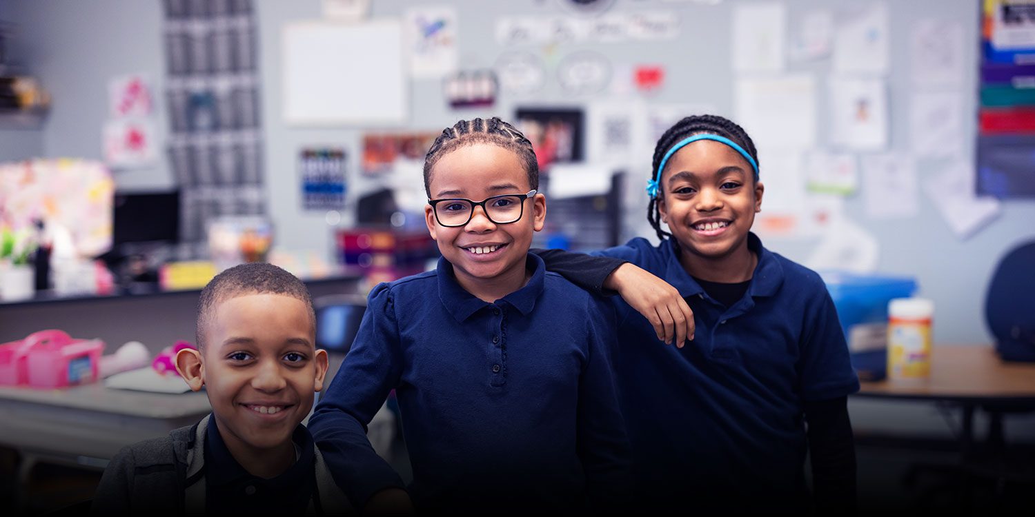 Elementary student smiling in classroom.